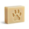 alt="Handcrafted natural soap bar with embossed paw print design, creamy beige color with smooth texture, displayed against white background showcasing professional spa-like quality"